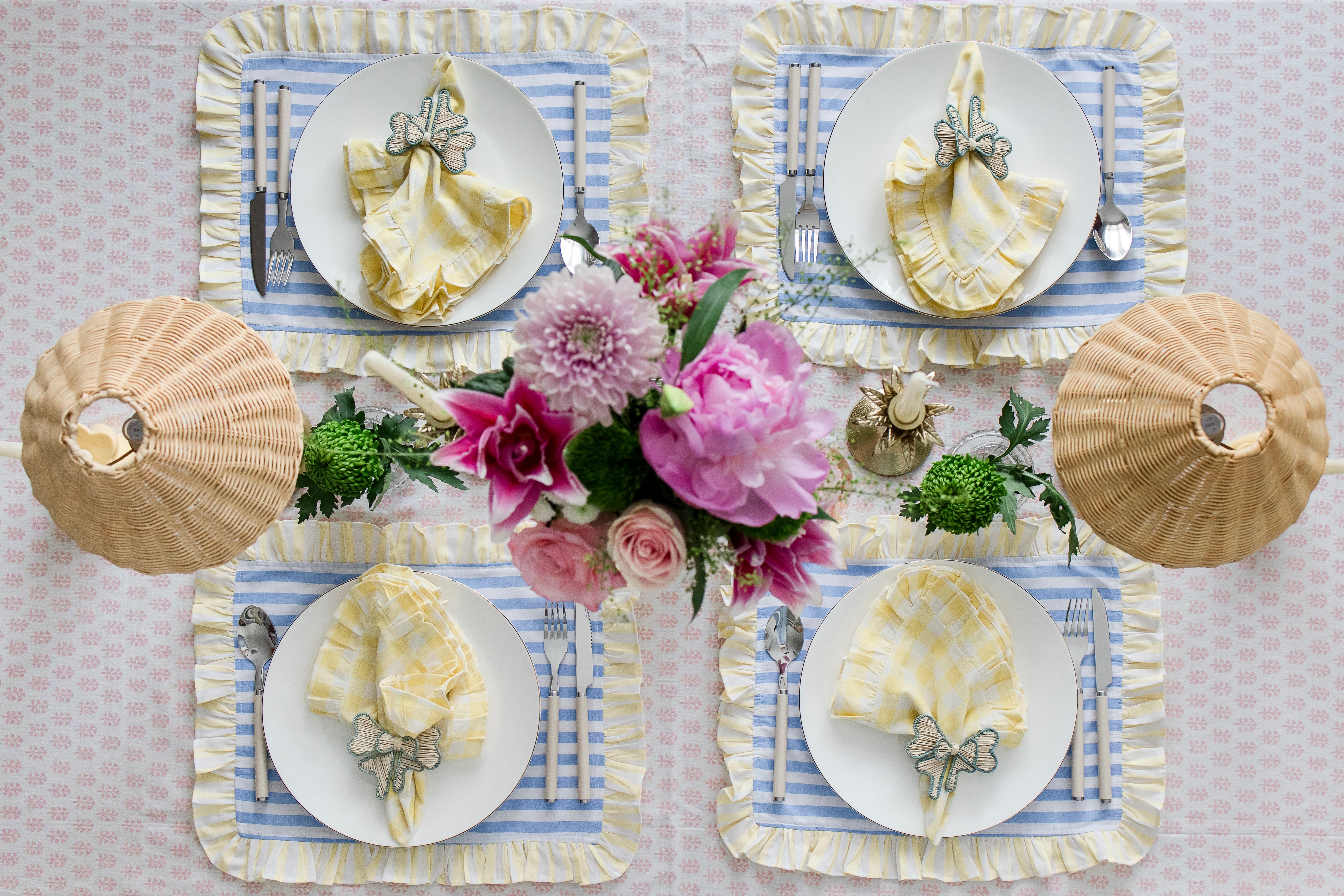 Soft pastel striped cotton placemats in blue and yellow with delicate frilled edges styled for a cottagecore garden brunch