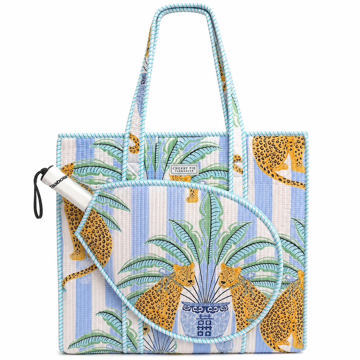 Blue striped quilted racquet tote bag with palm and leopard print and front tennis and padel racquet compartment by Cherry Pie Farmhouse, with padel racket