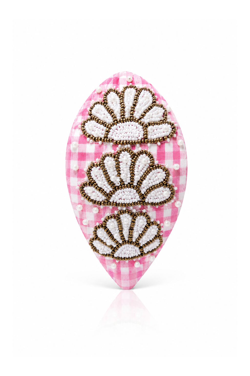 Decorative hair clip with floral patterns on a pink checkered background