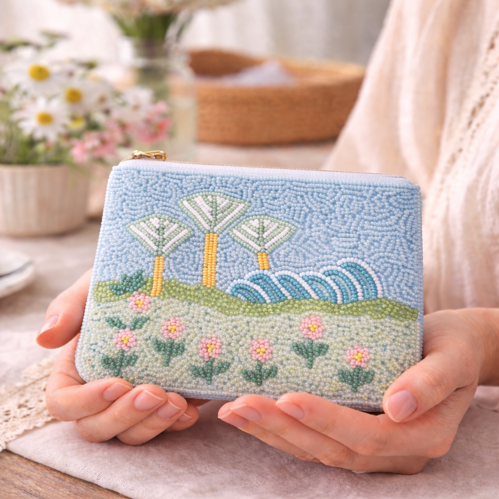 Handmade beaded purse with Singapore's gardens by the bay design held by a person.