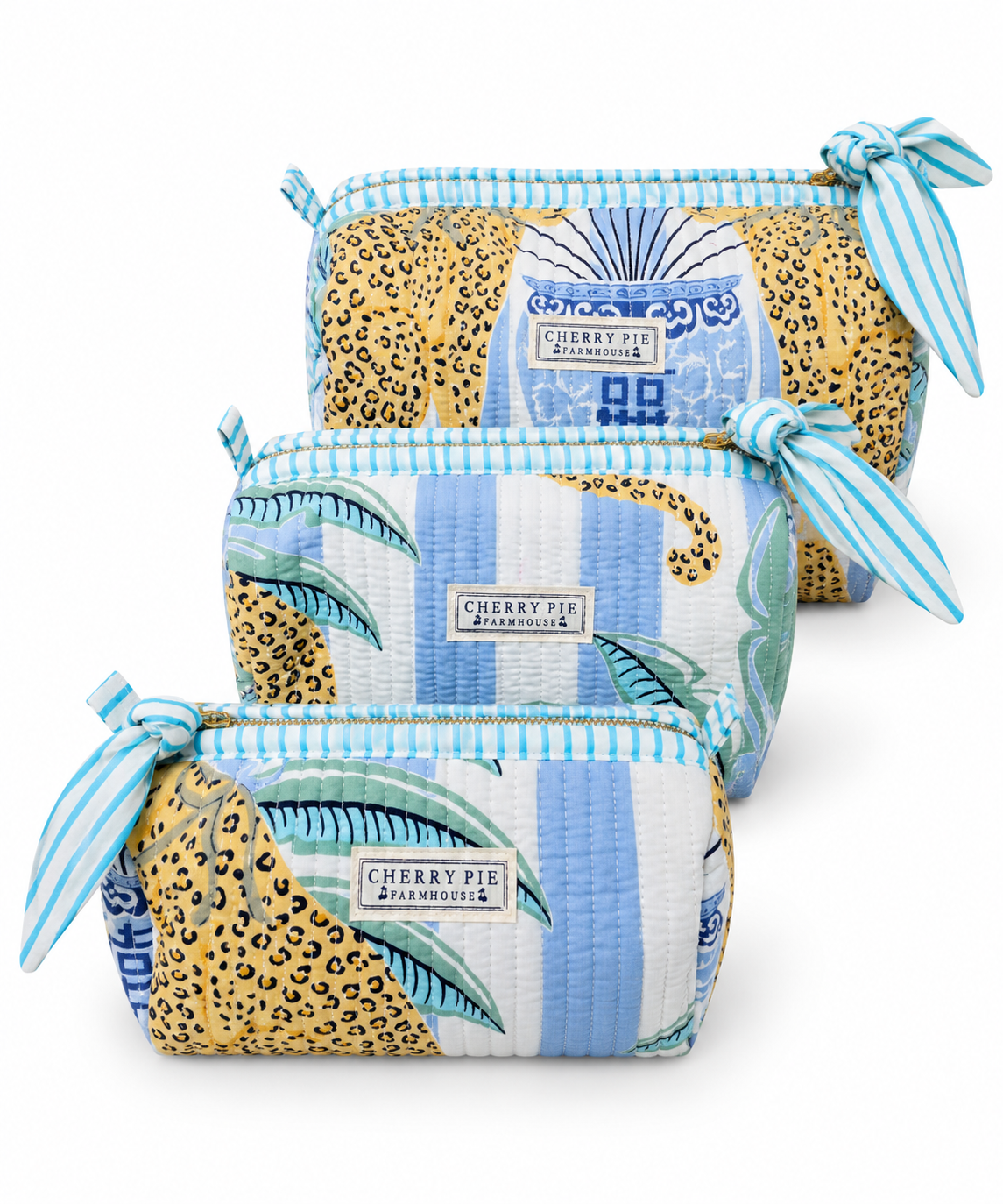 Palm Court quilted cotton zipper pouches in Small, Medium and Large on a white background.