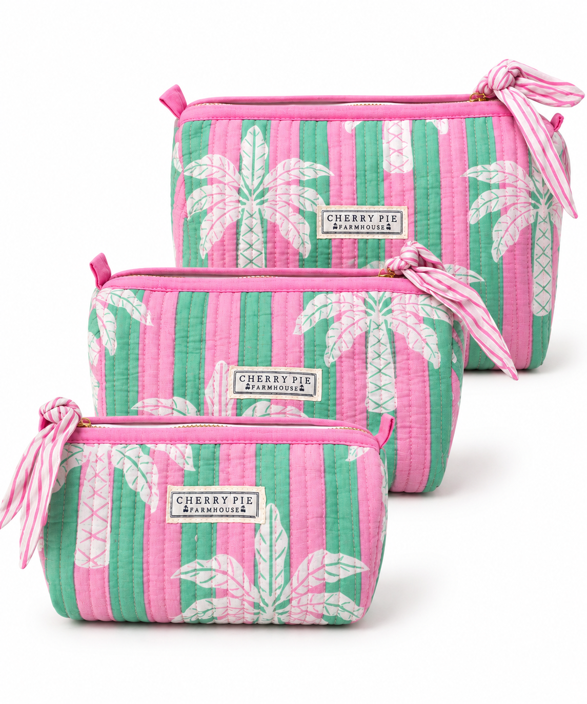 Pink Palm quilted cotton zipper pouches in Small, Medium and Large on a white background.