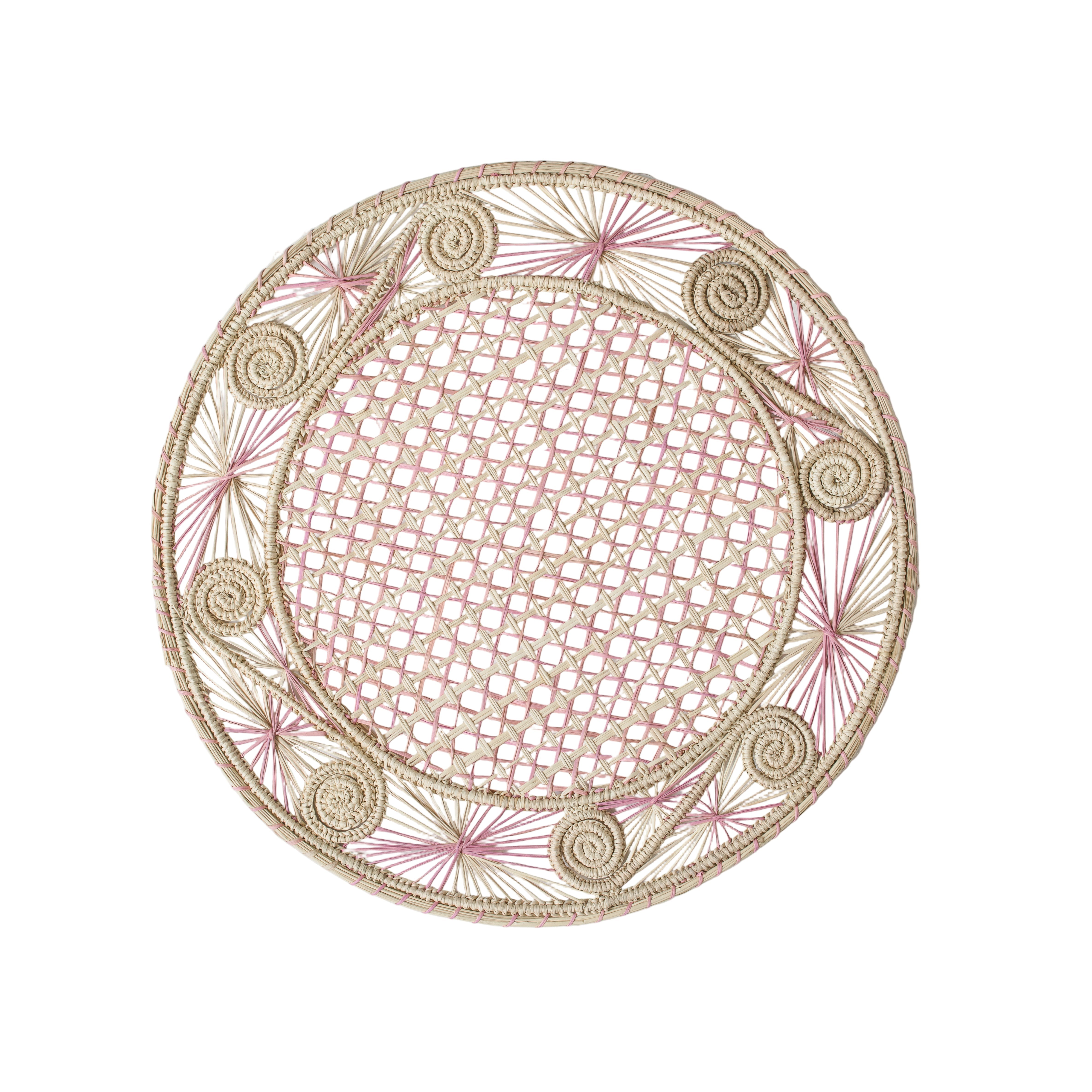 Round handwoven iraca palm placemats in Pink adding natural farmhouse texture to a rustic wooden table setting