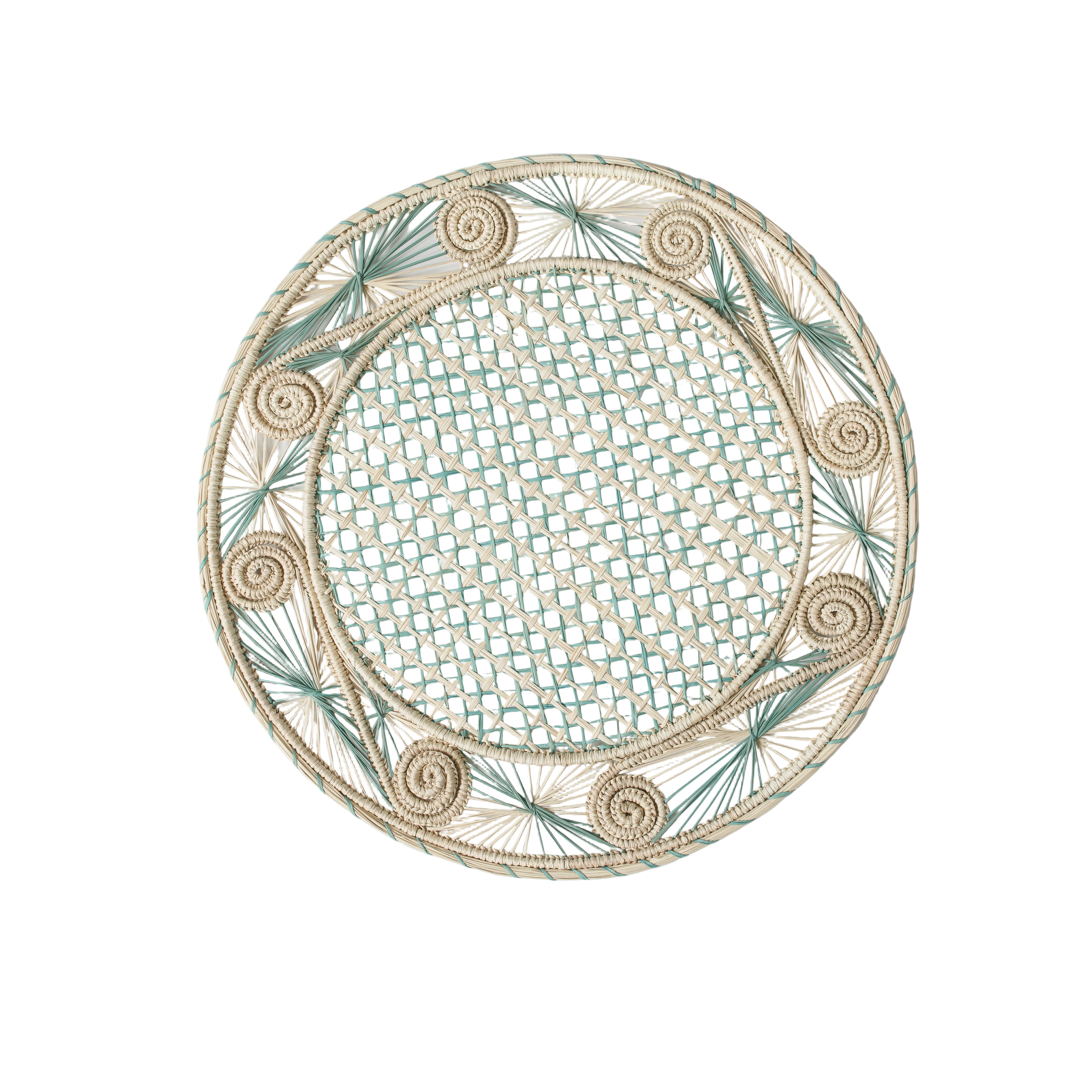 Round handwoven iraca palm placemats in blue adding natural farmhouse texture to a rustic wooden table setting