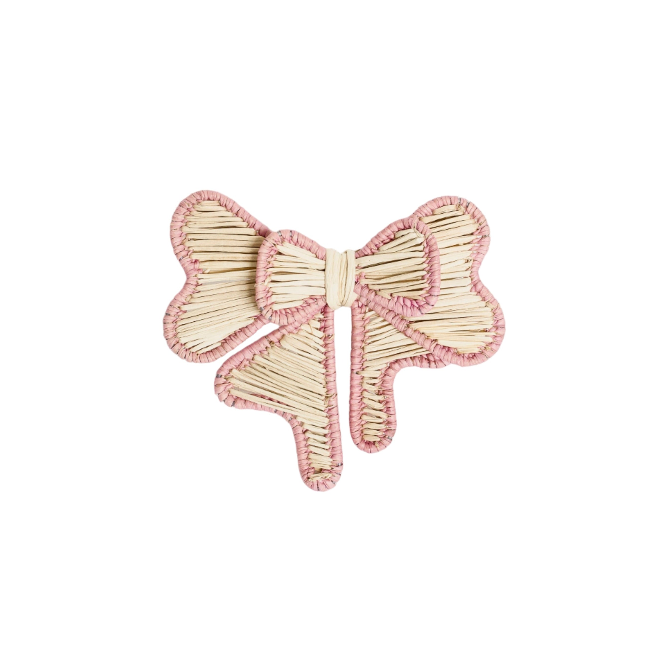 Handcrafted iraca palm bow napkin rings in pink wrapped around linen napkins on table