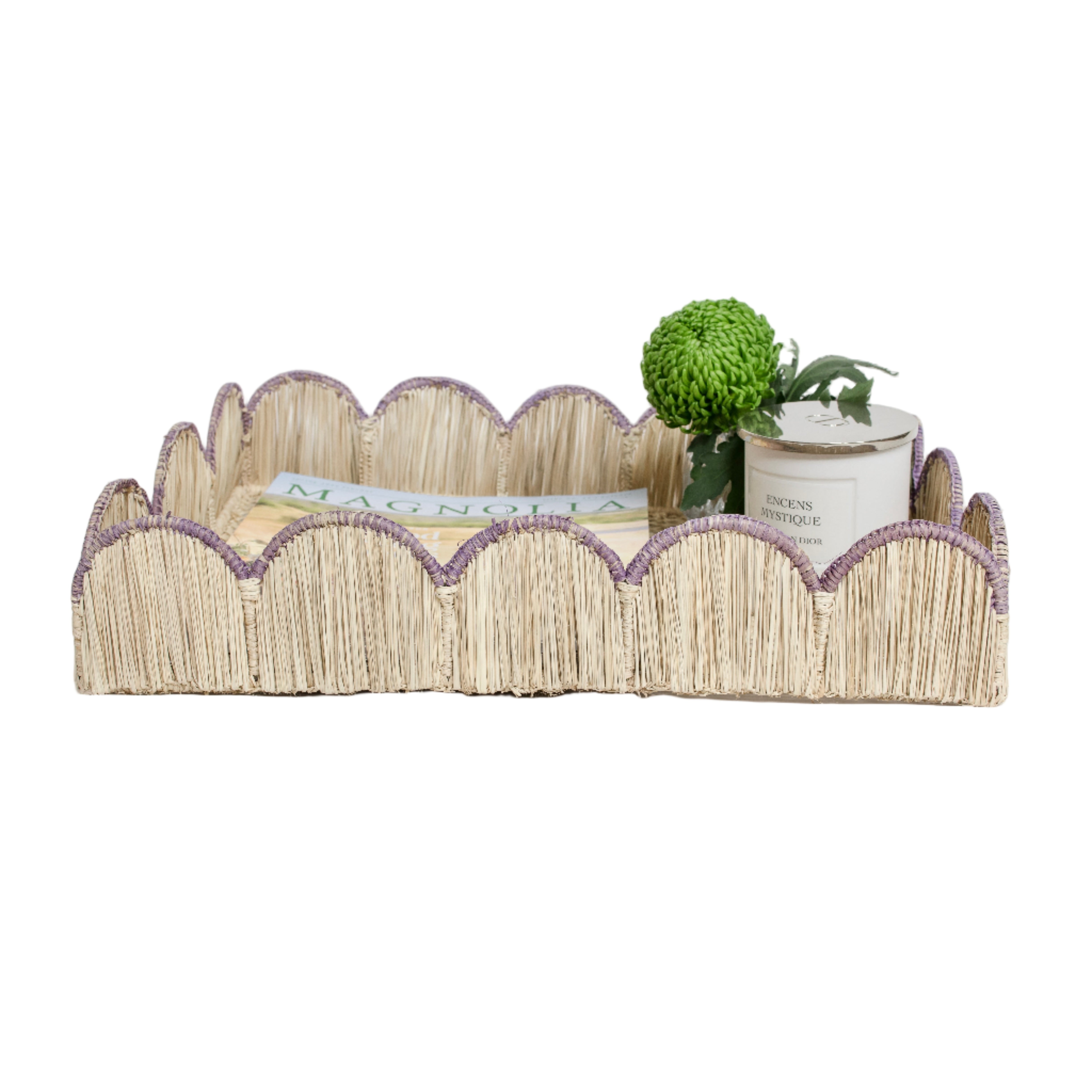 Woven iraca palm serving tray in purple lavender styled with magazine, plant and candle for table decor