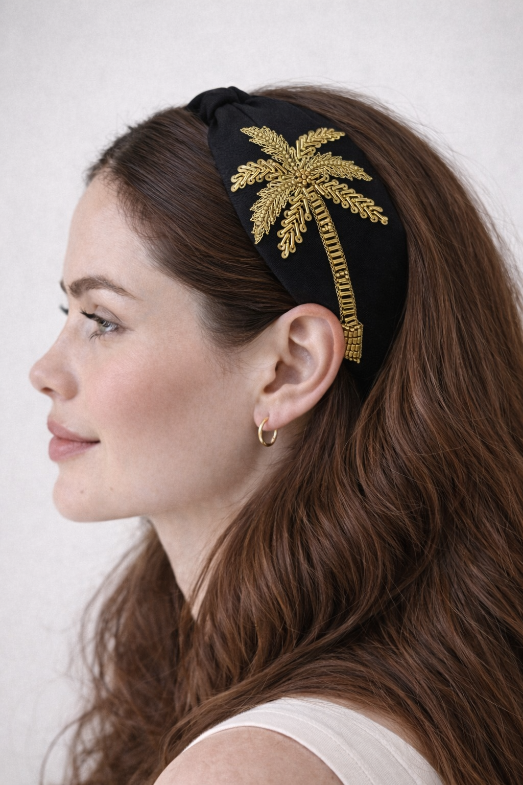 woman wearing a Tropical-inspired embellished headband with hand-beaded palm motif