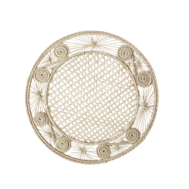 Round handwoven iraca palm placemats adding natural farmhouse texture to a rustic wooden table setting