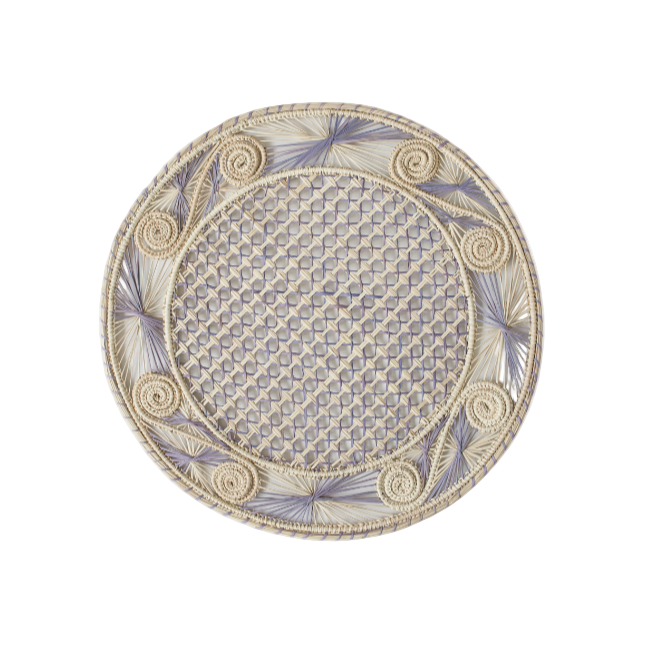 Round handwoven iraca palm placemats in purple lavender adding natural farmhouse texture to a rustic wooden table setting