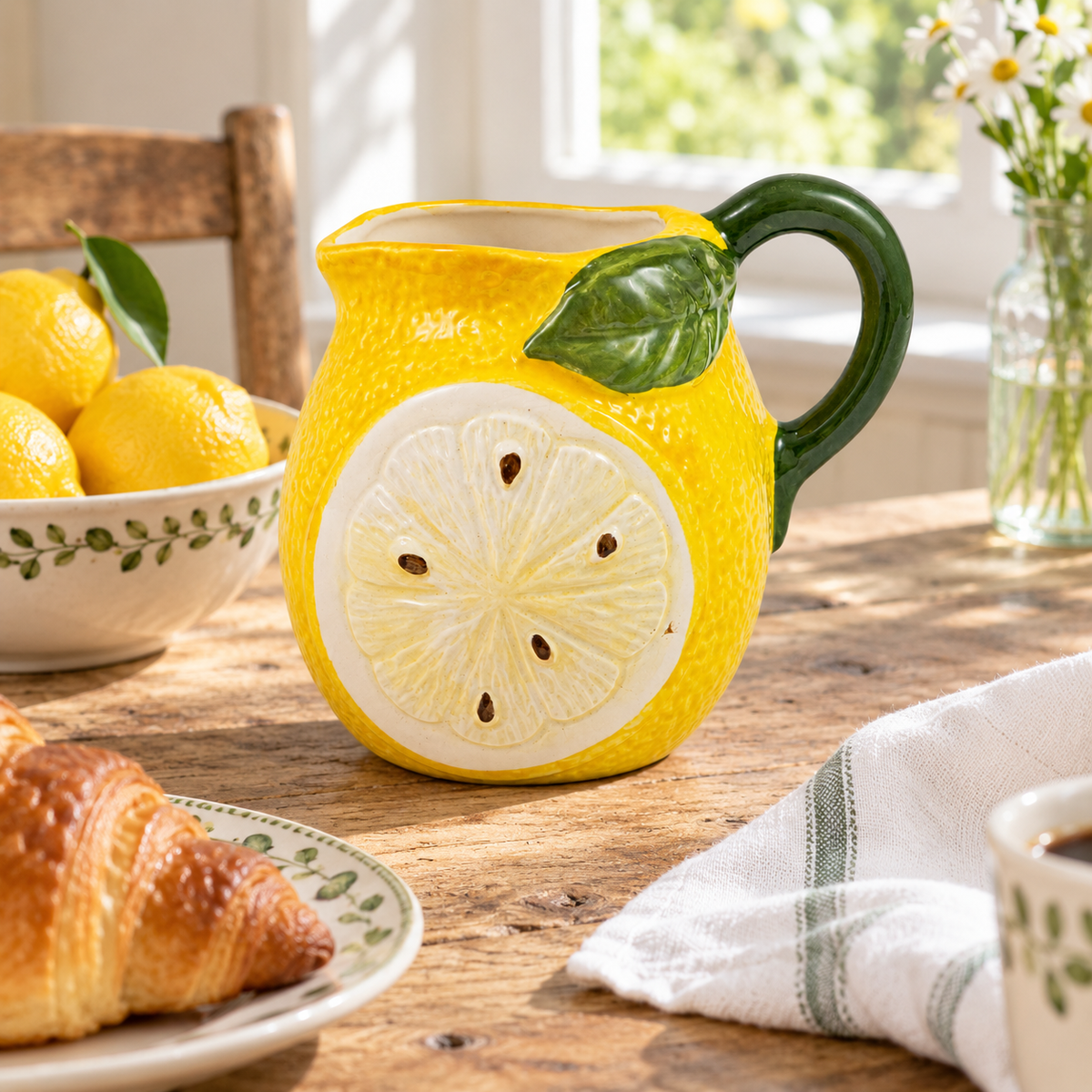 Large lemon ceramic milk jug styled on a sunny farmhouse breakfast table