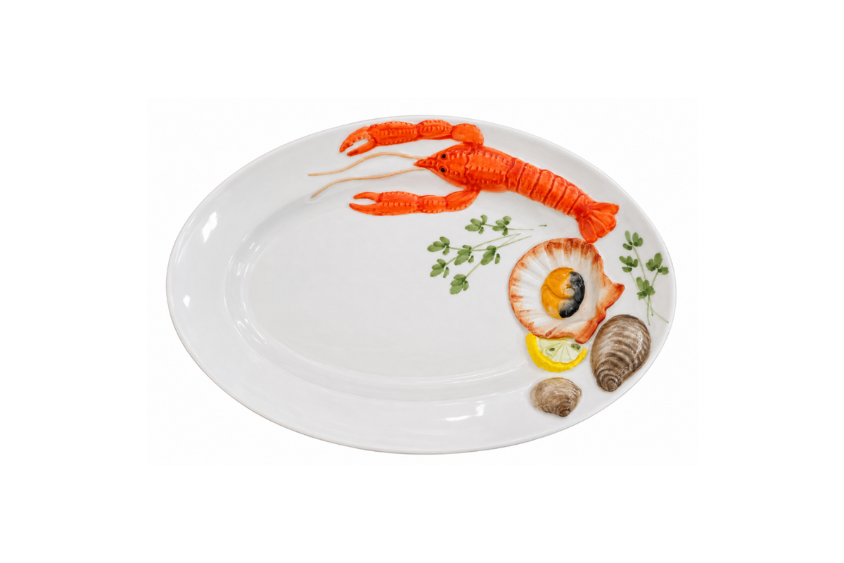 White oval ceramic serving plate with hand-painted red lobster, shells, lemon and herbs.
