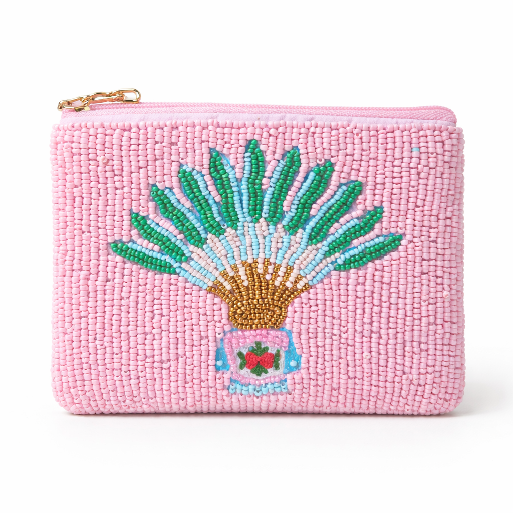 Pink beaded pouch with embroidered traveller's palm with peranakan motif design on a white background