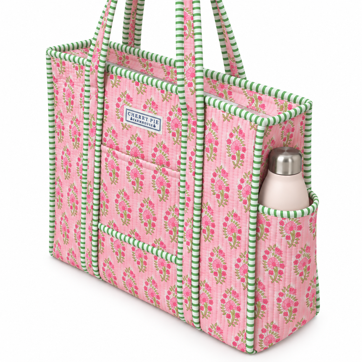 Side view of pink floral quilted tote showing green striped trim, outer bottle pocket and concealed zip closure